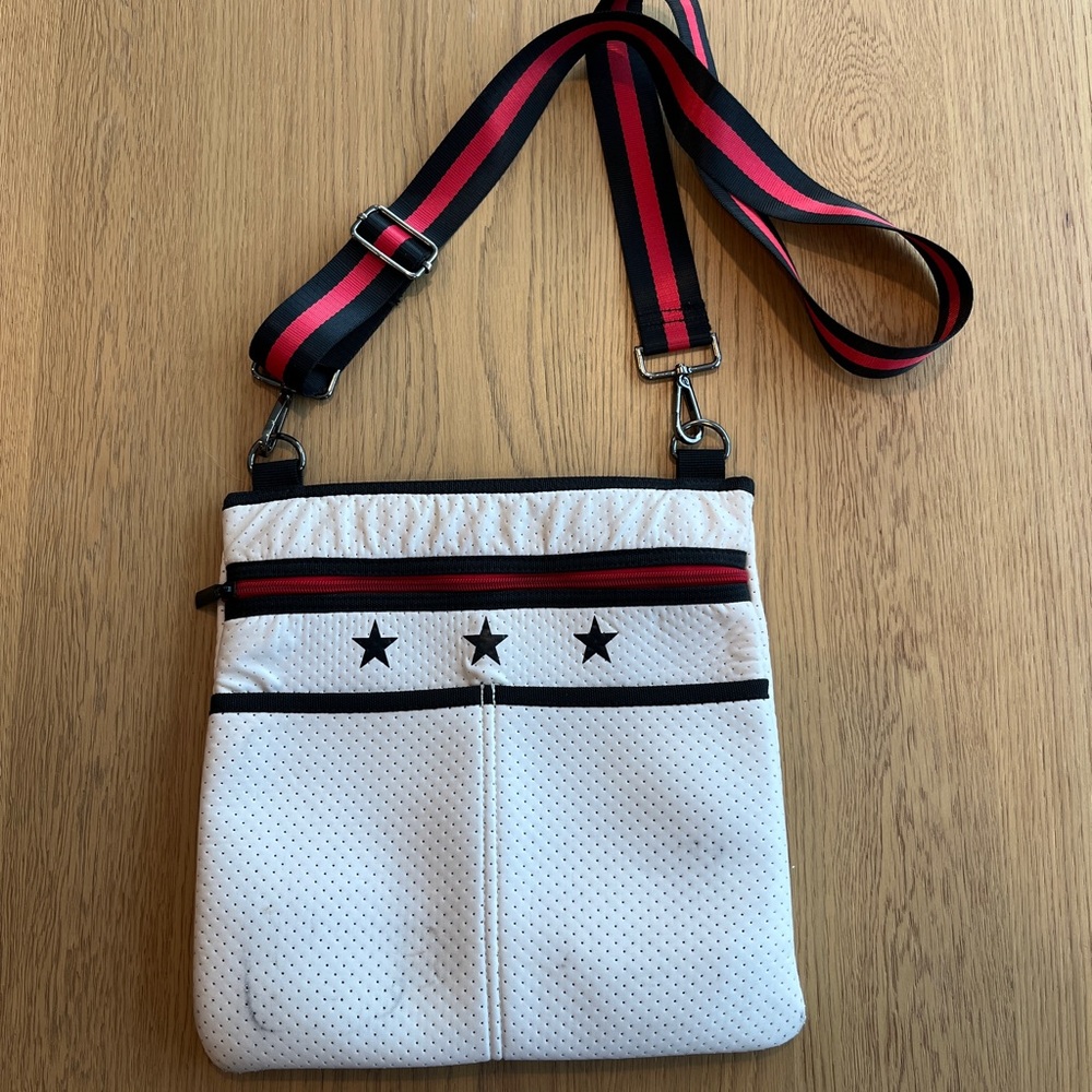 HAUTE SHORE Peyton Frame Crossbody White Bag with Black Stars and Red Accents